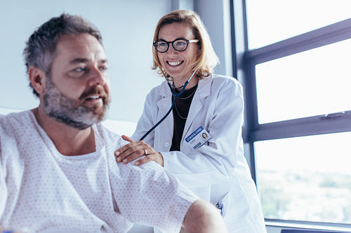 Medical examination of mature man in hospital ward
