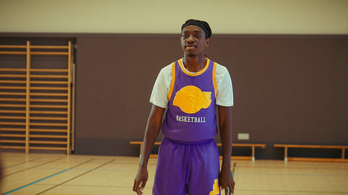 Young men playing basketball in gym