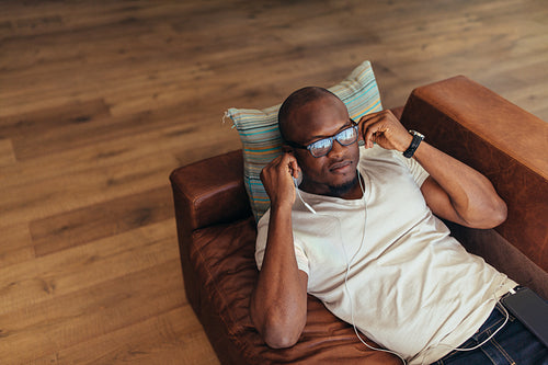 Man relaxing while listening to music