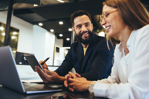 Happy entrepreneurs having a discussion in an office