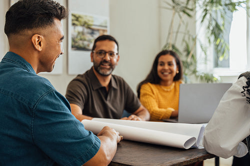 Architects brainstorming design ideas in a modern workspace with a teamwork focus