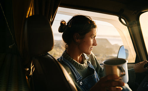Woman in a vehicle having a cozy morning moment