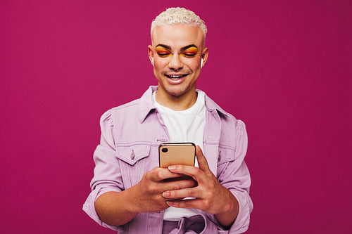 Queer man playing his favourite playlist