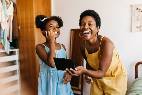 Mother and daughter happiness: Makeup fun in the bedroom