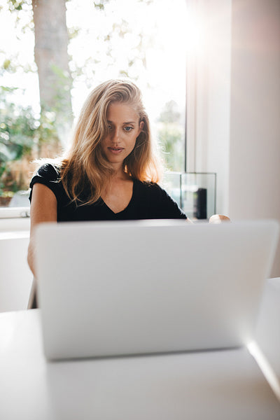 Beautiful female surfing the net on laptop