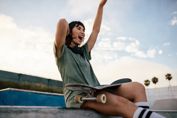 Female skateboarder enjoying herself at skate park