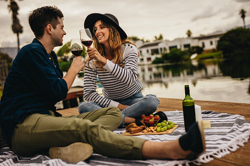 Smiling couple on a date near a lake