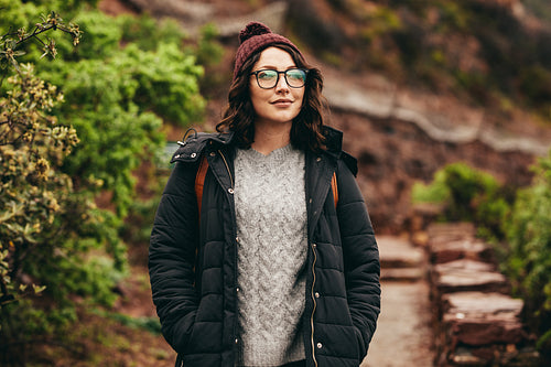 Beautiful tourist standing on stone stairs on mountain
