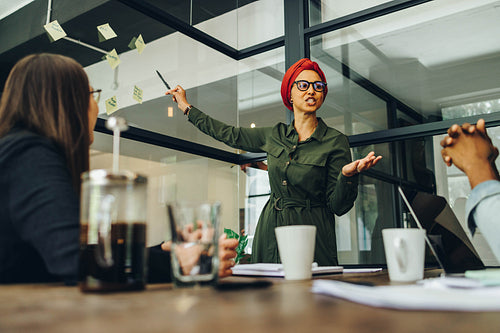 Creative businesswoman sharing her ideas with her team