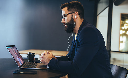 Modern businessman attending a virtual meeting