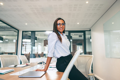 Happy businesswoman smiling at the camera in a boardroom