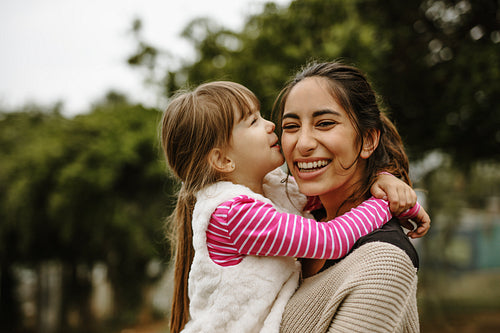 Girl kissing her nanny