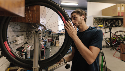 Mechanic repairing a bicycle in workshop