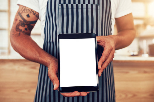 Man in a coffee shop with digital tablet