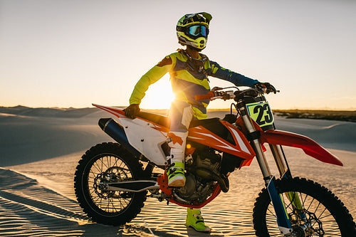 Motocross biker with his bike during a race