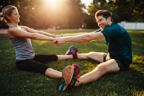 Young health couple doing stretching exercise