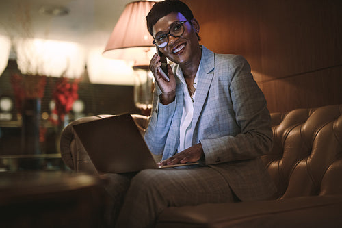 Businesswoman on trip working from hotel lobby