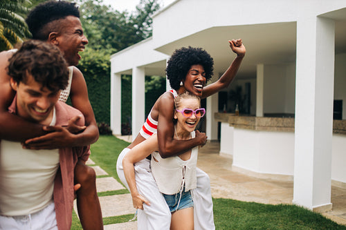 Siblings and friends play tag at sunny vacation home