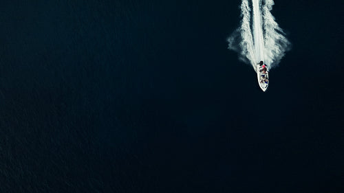 Boat moving fast across deep ocean water