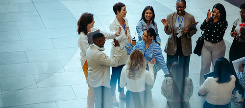 Diverse group of employees celebrating success while networking and building strong colleague relationships