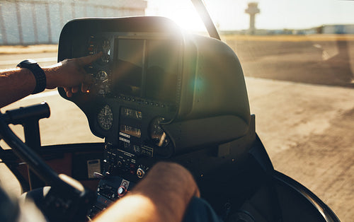 Helicopter pilot checking gauges on the instrument panel
