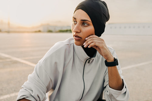 Sporty woman with a hijab looking away outdoors
