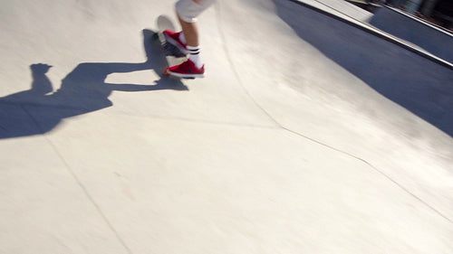 Athletic young man skateboarding in a skate park
