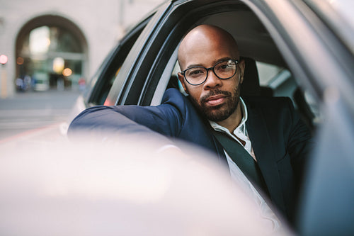 African businessman driving car in the city