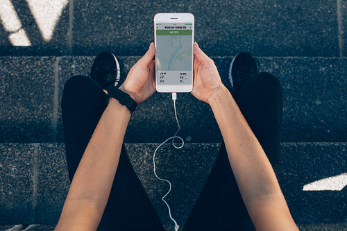 Woman checking the summary of her run on smartphone