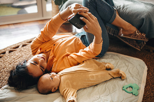 Mother taking selfie with baby son at home