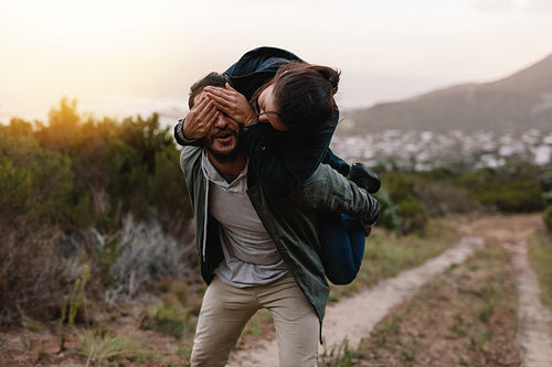 Playful young couple enjoying themselves in countryside