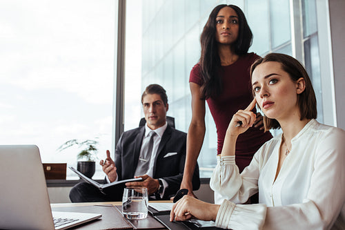 Woman with colleagues during a meeting in office