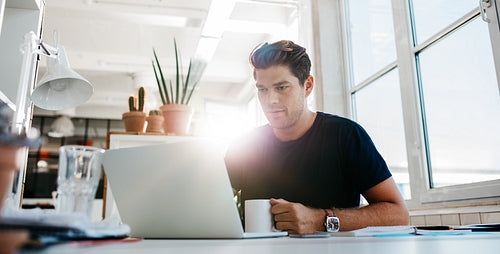 Young businessman working on laptop computer