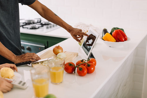 Unrecognizable couple following an online recipe
