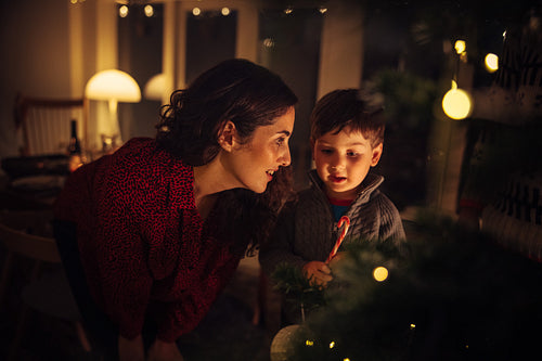 Mother and son decorating Christmas tree