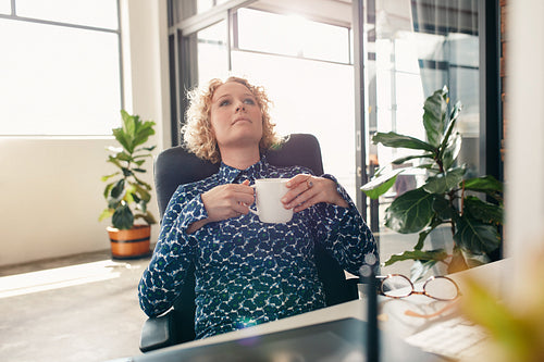 Thoughtful businesswoman at desk in office
