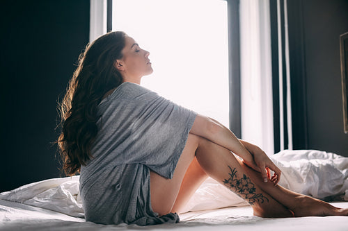 Young woman relaxing on her bed