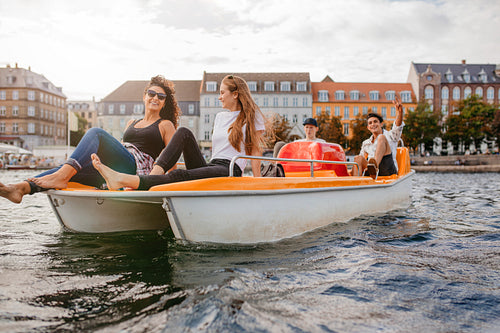 Teenagers relaxing on boat in the lake