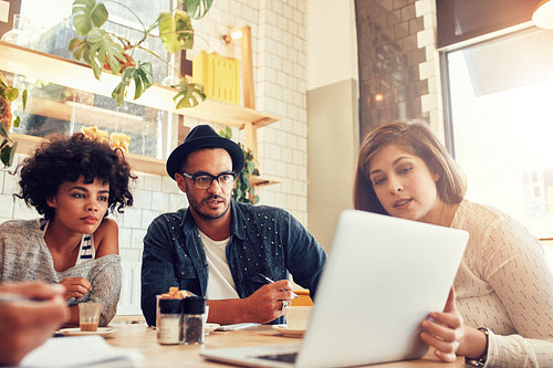 Business team discussing new project ideas at a cafe