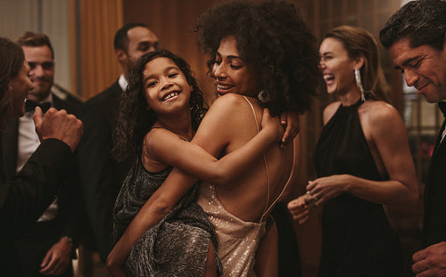 Girl dancing with her mother at a gala night event