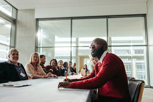 Diverse group of professionals engaged in a training workshop in a modern conference room setting