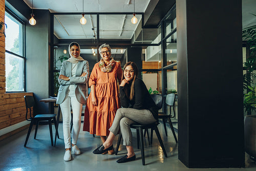 Multiethnic female entrepreneurs smiling at the camera in an off