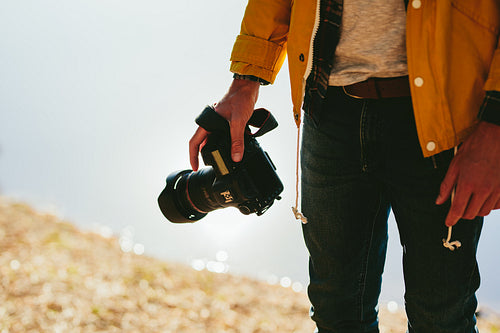 Close up of a photographer holding his dslr camera