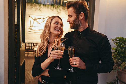 Romantic married couple making a toast with champagne glasses