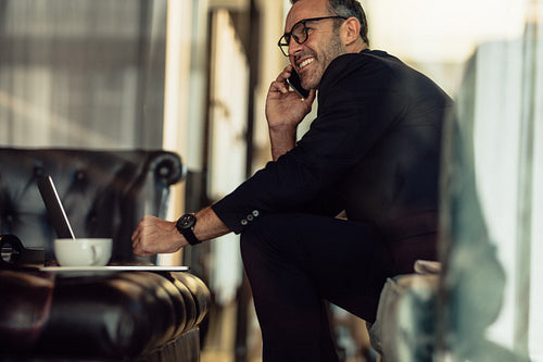Businessman working from hotel lobby