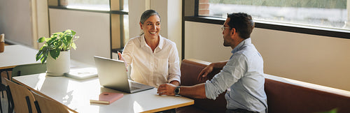 Business professional talking with coworker