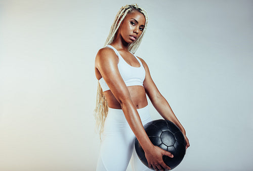 Close up of african american fit woman with a medicine ball
