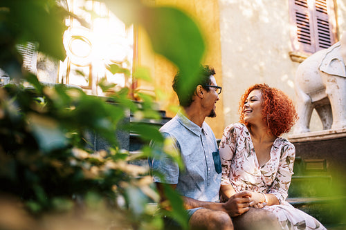 Young romantic couple in love talking in the garden.