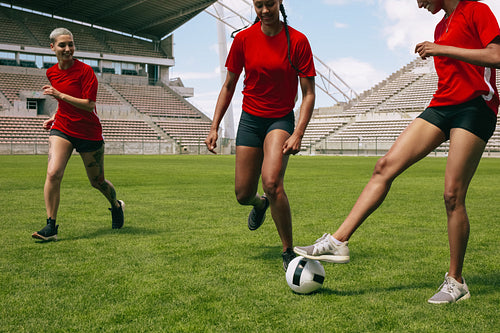 Women playing soccer on the field