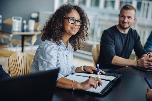 Female entrepreneur having meeting with team